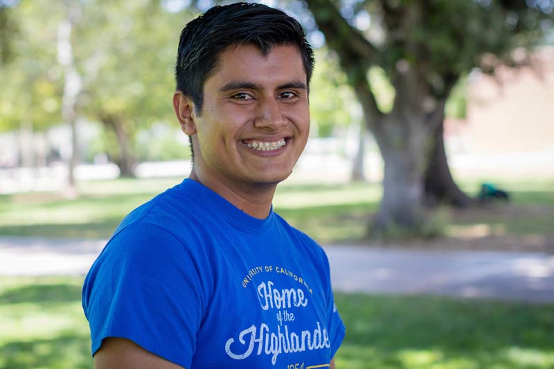 Mathematics major, Jorge Juarez Duarte smiles in a shady spot of the UCR campus