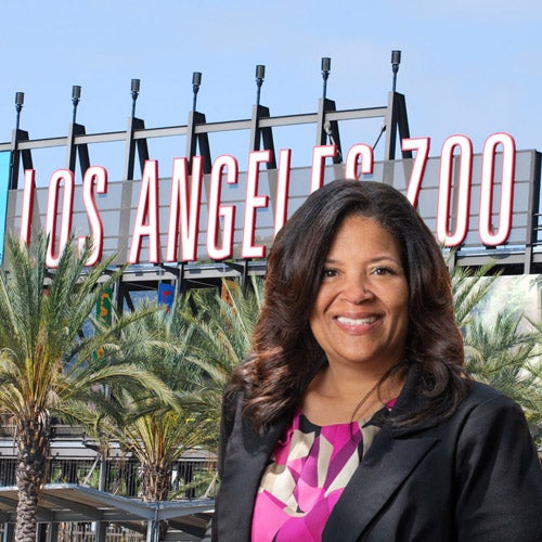 Denise Verret, UCR alumna and director of an Association of Zoos and Aquariums accredited institution, stands in front of the Los Angeles Zoo entrance.