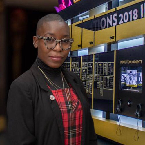 Nwaka Onwusa, UCR alumna and chief curator and vice president of curatorial affairs for the Rock & Roll Hall of Fame in Cleveland, OH, stands in front of a display at the Grammy Museum in Los Angeles, California.