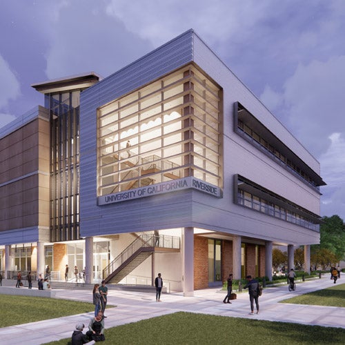 An outside rendering of the UCR's Student Success Center in the evening as students enter and pass by.