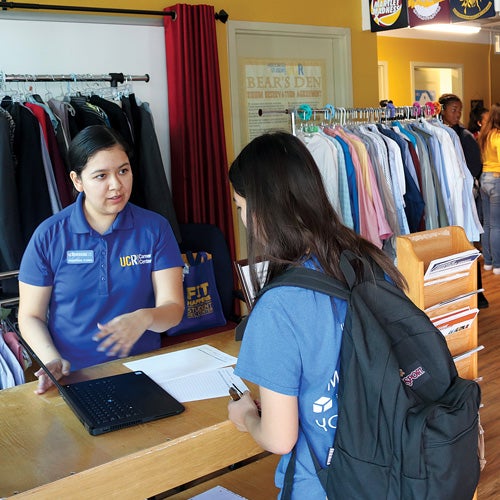 A UCR student comes to the counter at the R’Professional Career Closet to access free professional attire.