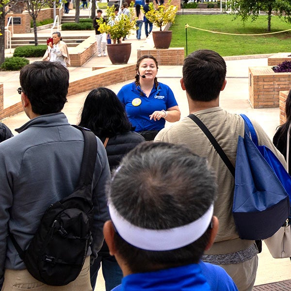 A Campus Tours Guide leads visitors on Highlander Day.