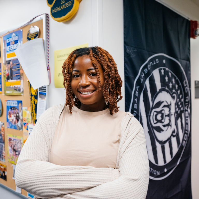 A female student poses inside the Veterans Resource Center within Costo Hall on the UC Riverside campus.