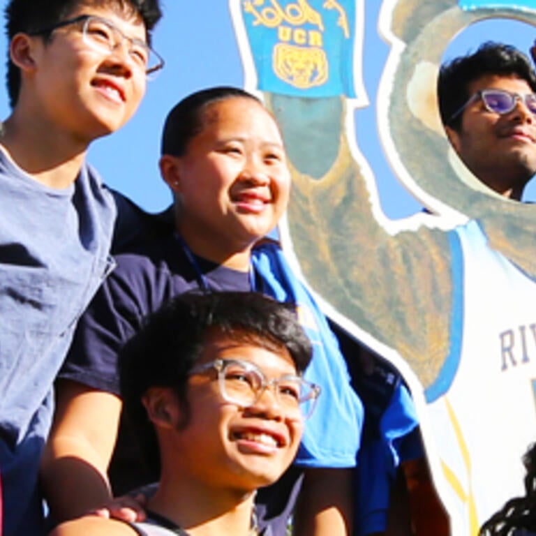 A group of students pose for a photo during an event on the UC Riverside campus.