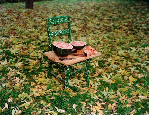 Halved watermelon on green chair
