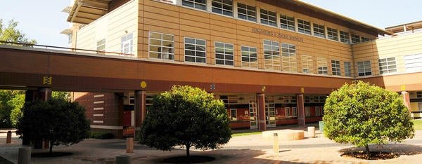 A front view of UCR's Humanities & Social Sciences Building and surrounding kumquat trees.