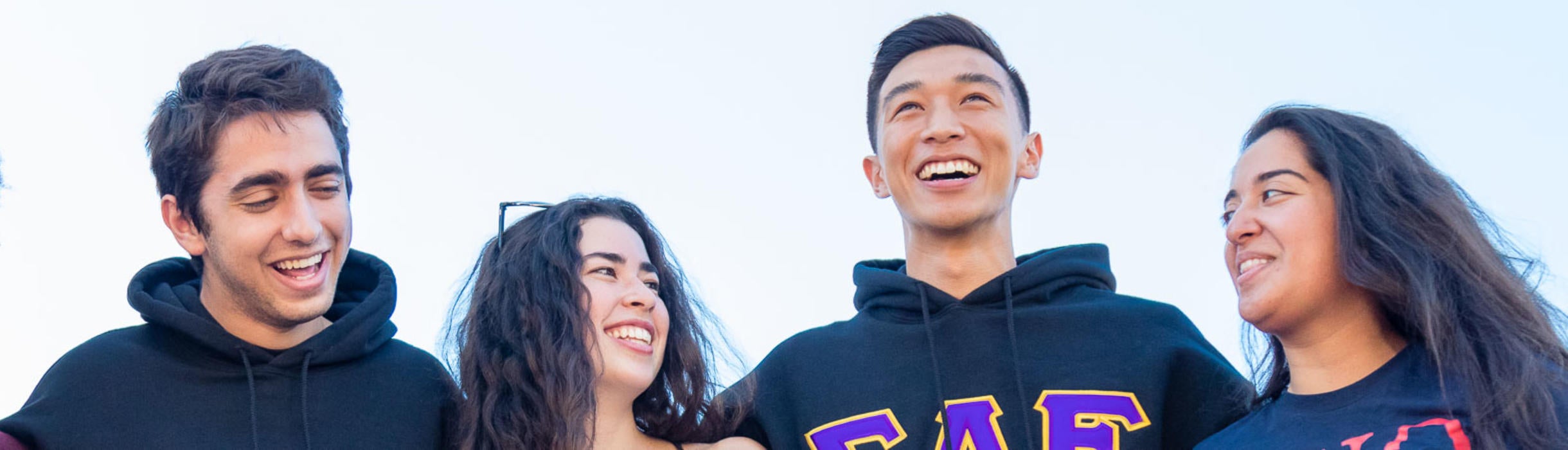 Five UC Riverside students share a happy moment on campus.