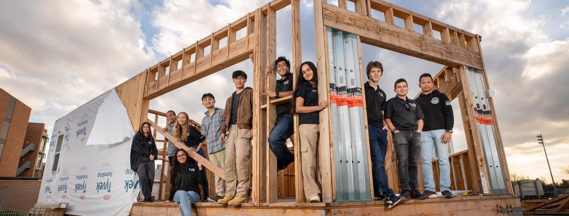 UC Riverside mechanical engineering undergrads at an energy-efficient home they designed and building