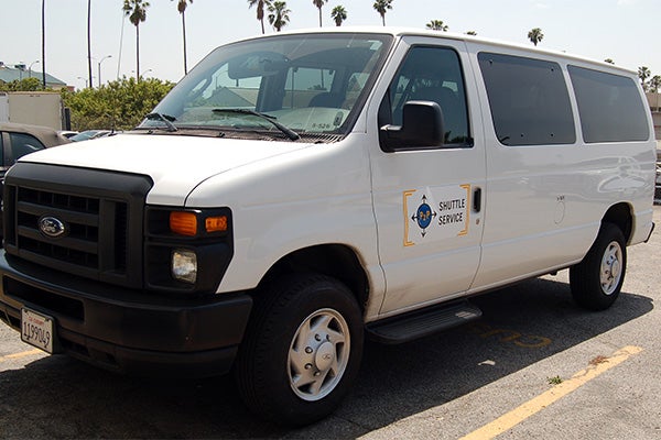 Point-to-Point Shuttle Service A roomy Point-to-Point Shuttle Service van that is used to transport students to and from the campus and their off-campus home.