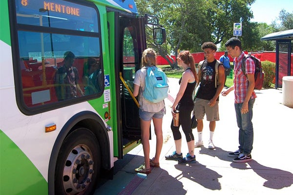 Students board a Riverside Transit Agency bus to explore the city.