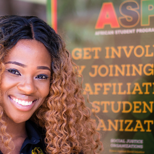 Smiling black female student posses in front of African Student Programs. 